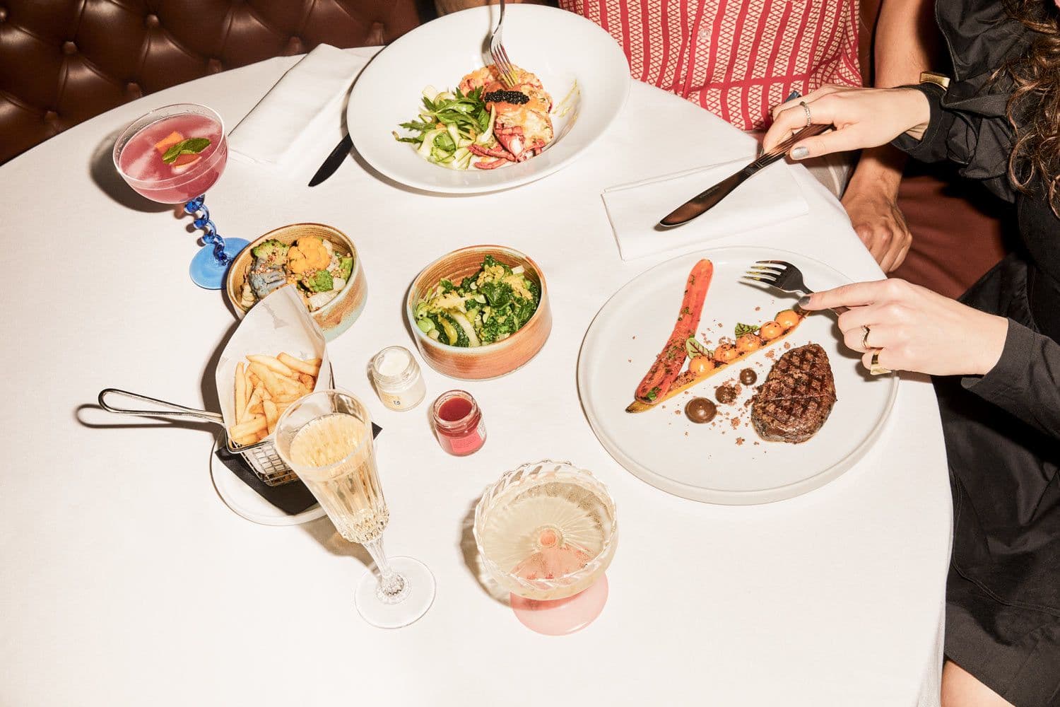 An elegant meal of lobster, steak, and frites